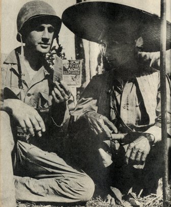  Soldier with booklet on how to get along with native people 