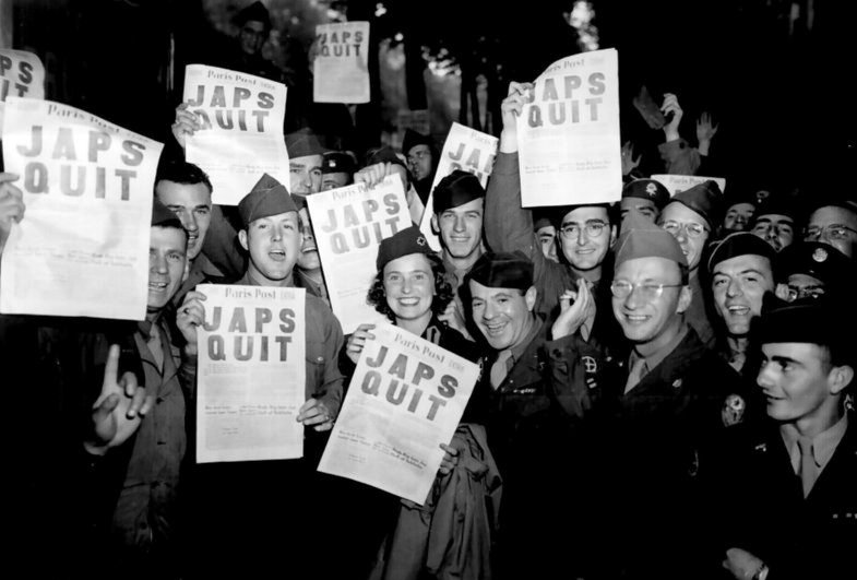  Americans celebrate with newspaper headline 